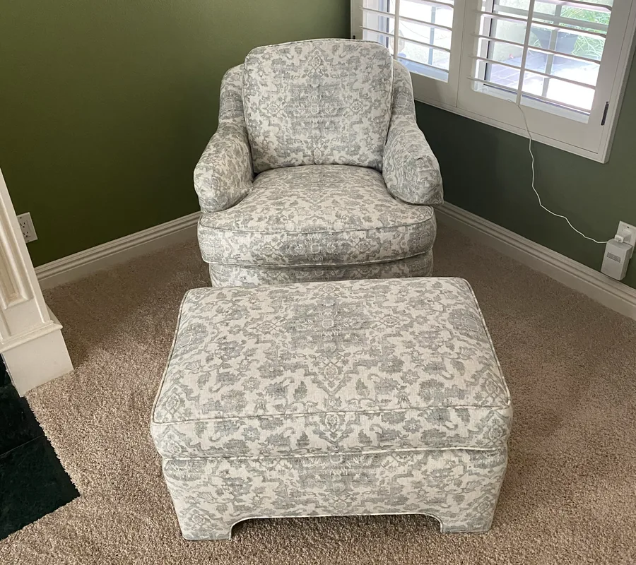Armchair and matching ottoman recovered in a floral print