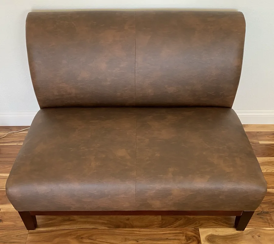 Built-in banquette seating upholstered in brown leather