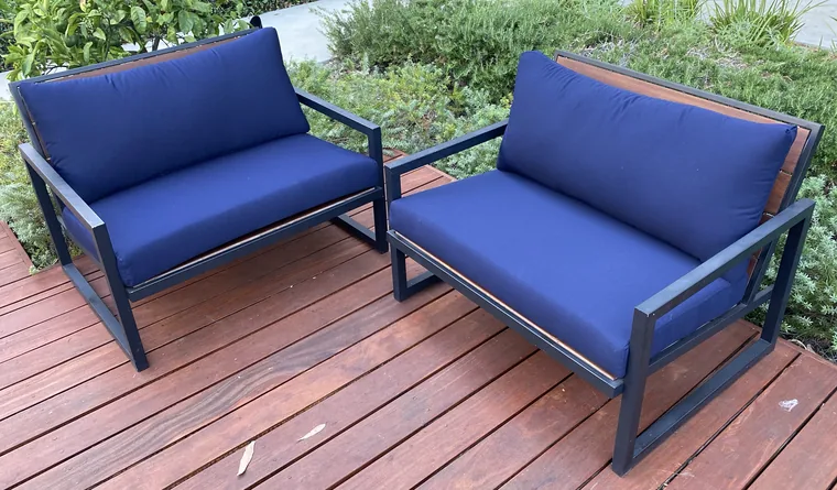 Pair of outdoor lounge chairs in blue weatherproof fabric