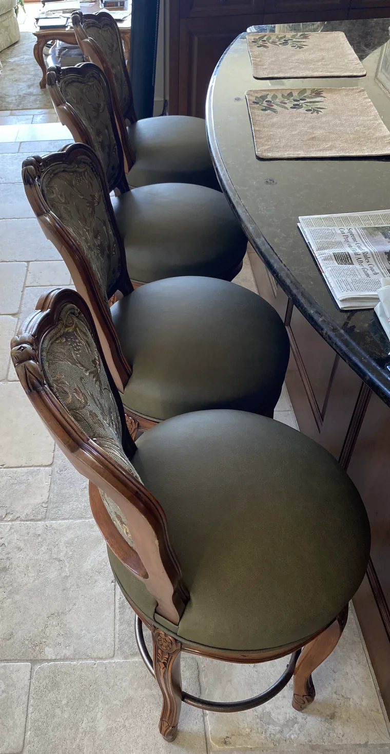 Carved dining chairs recovered in olive velvet