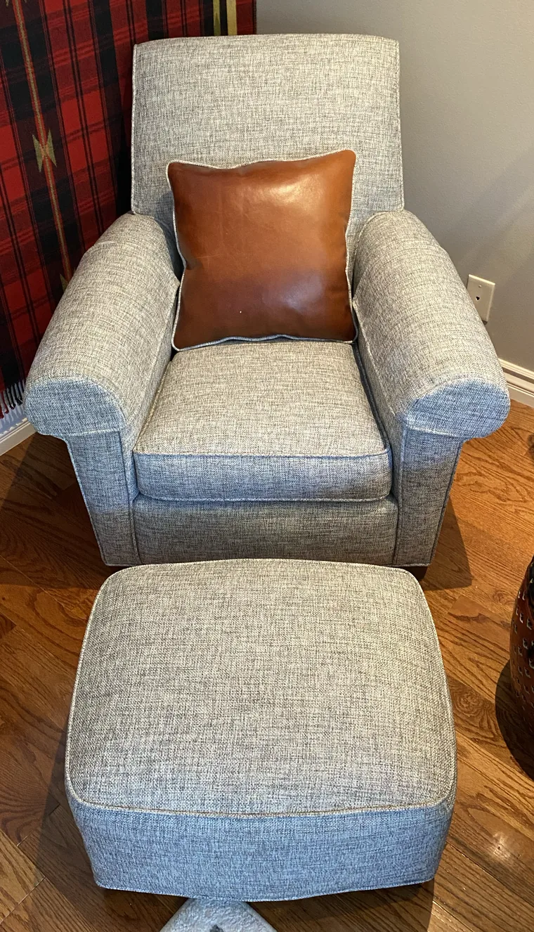 Club chair and ottoman in grey with a leather pillow