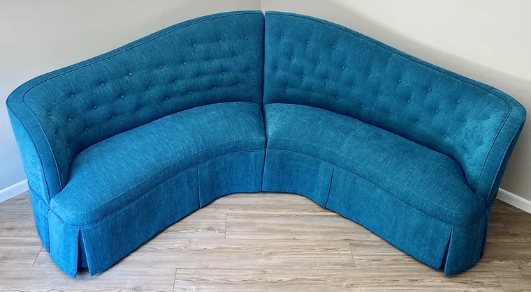 Curved corner banquette tufted in teal