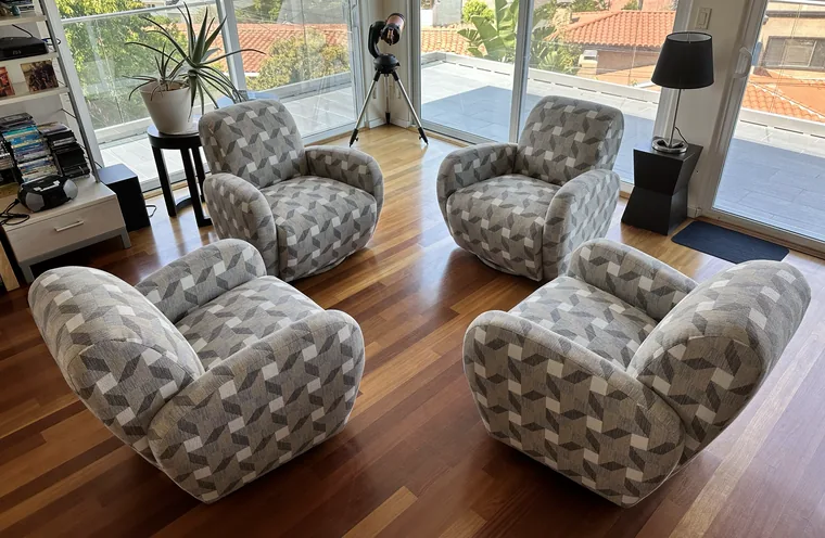 Set of four swivel barrel chairs recovered in a geometric print