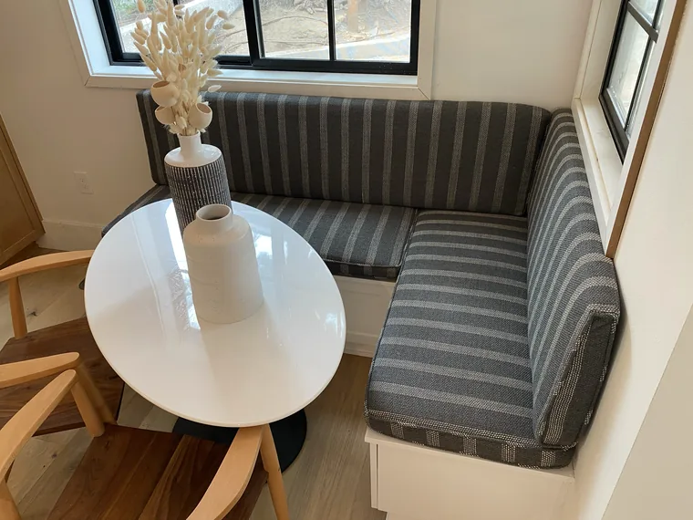 Built-in dining banquette recovered in a grey stripe