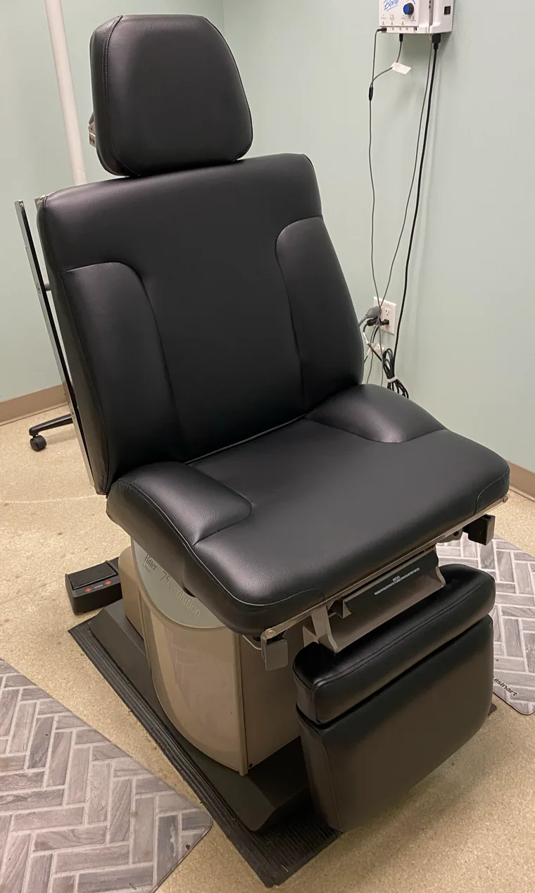 Medical exam chair reupholstered in black vinyl