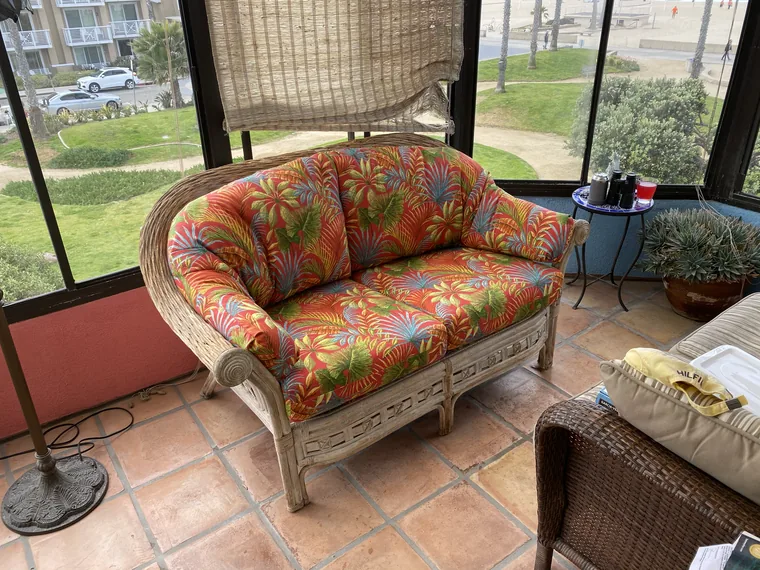 Rattan loveseat with new tropical floral cushions
