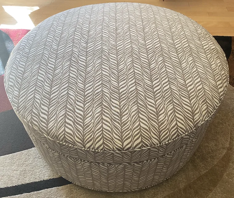 Round ottoman in a herringbone weave