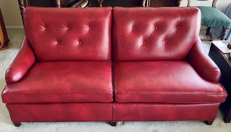 Tufted loveseat in red leather