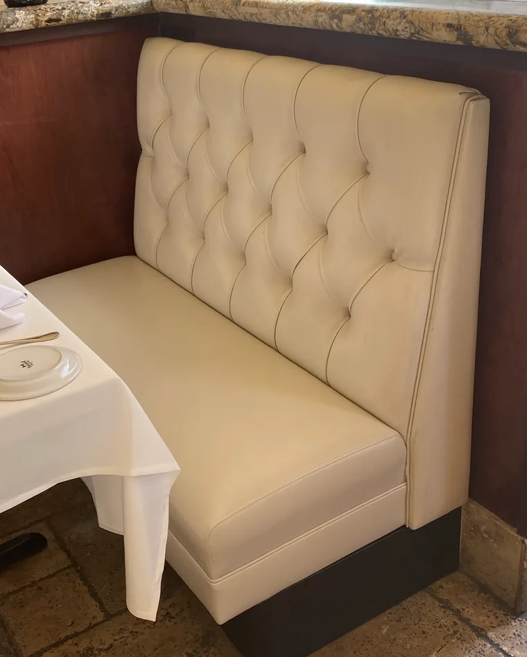Tufted restaurant banquette in cream