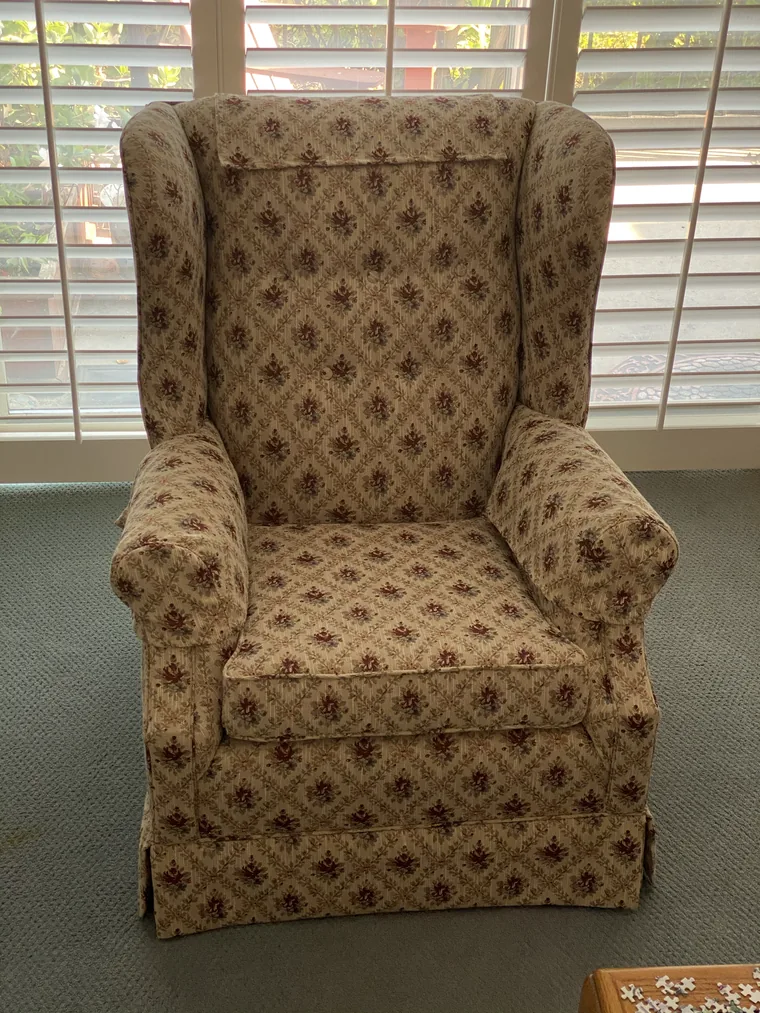 Wingback chair recovered in a brown damask